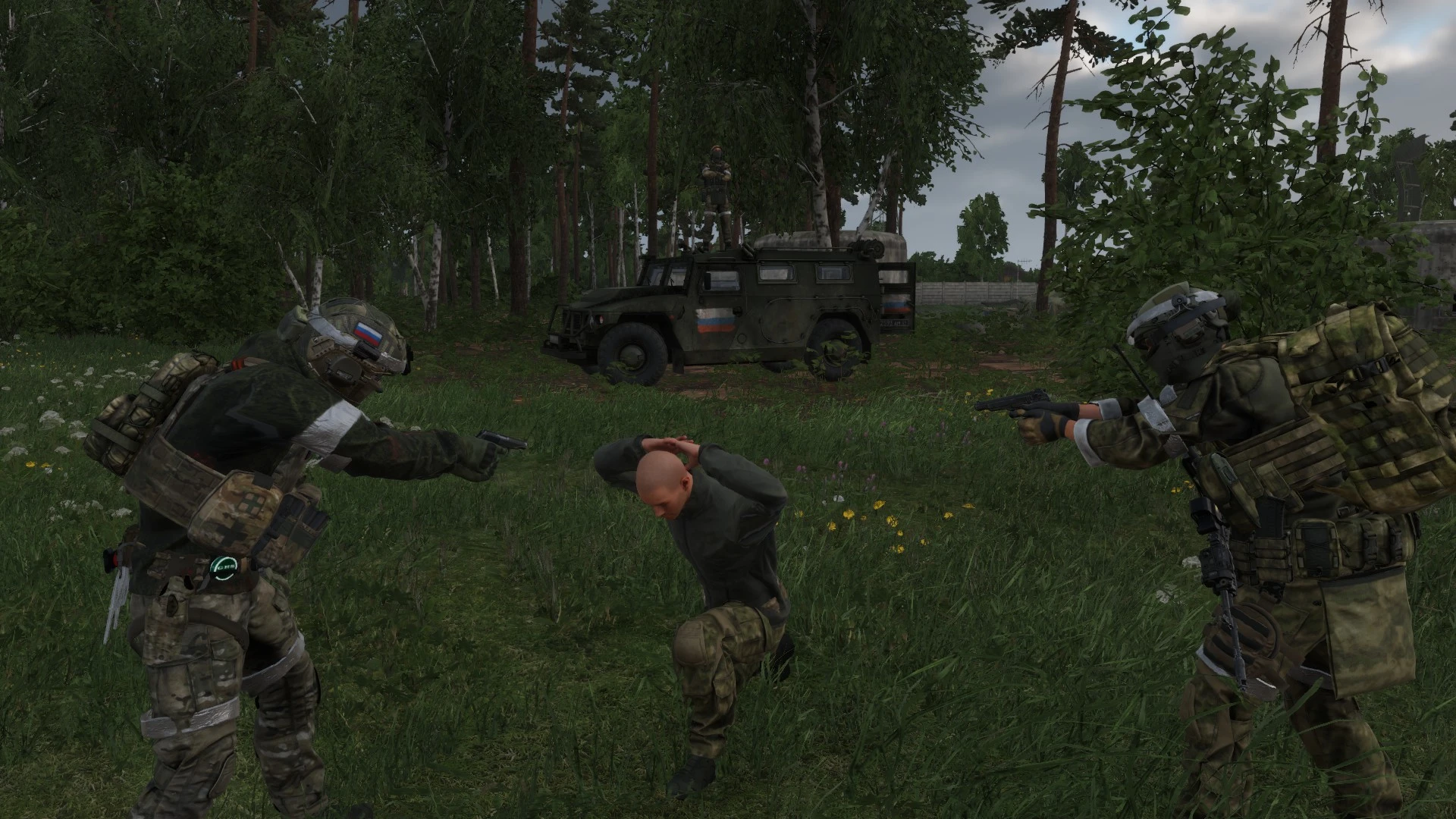 Two operators detaining a prisoner beside a Tigr vehicle